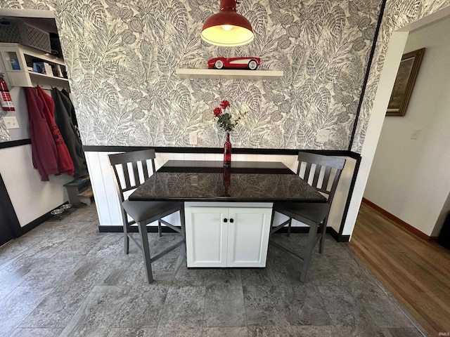 dining area with wallpapered walls, dark wood-style floors, and baseboards