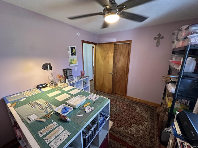 interior space with a ceiling fan, a closet, and baseboards