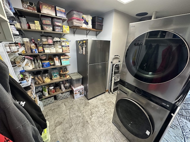 washroom featuring stacked washer / drying machine