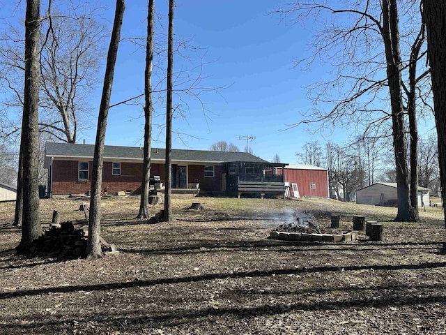 view of front facade with driveway and brick siding