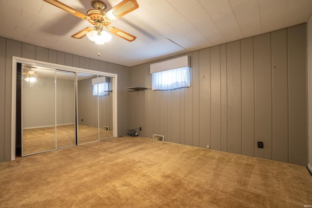 unfurnished bedroom featuring ceiling fan, carpet floors, and visible vents