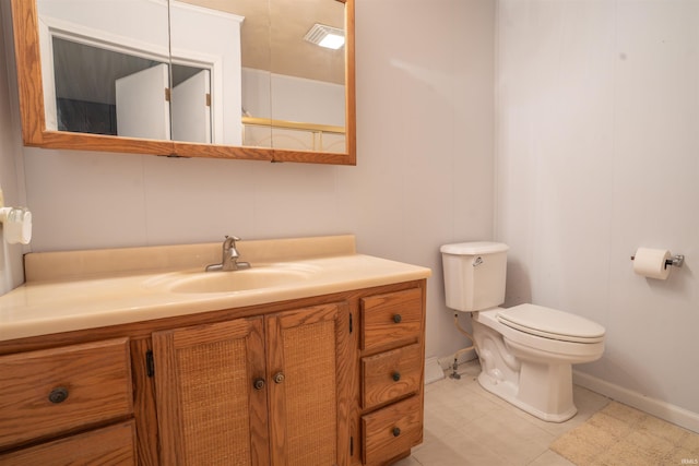 bathroom with tile patterned flooring, vanity, and toilet