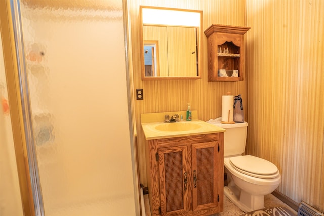 bathroom with a baseboard radiator, a shower stall, vanity, and toilet