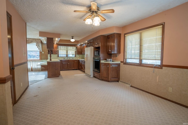 kitchen with light countertops, light carpet, a textured ceiling, white fridge with ice dispenser, and oven