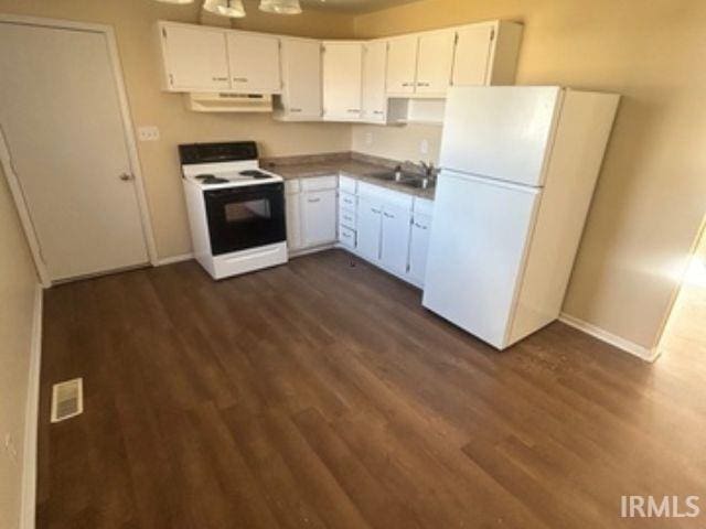 kitchen with electric stove, under cabinet range hood, freestanding refrigerator, and white cabinets