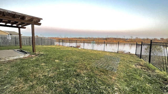 view of yard featuring a water view and a fenced backyard