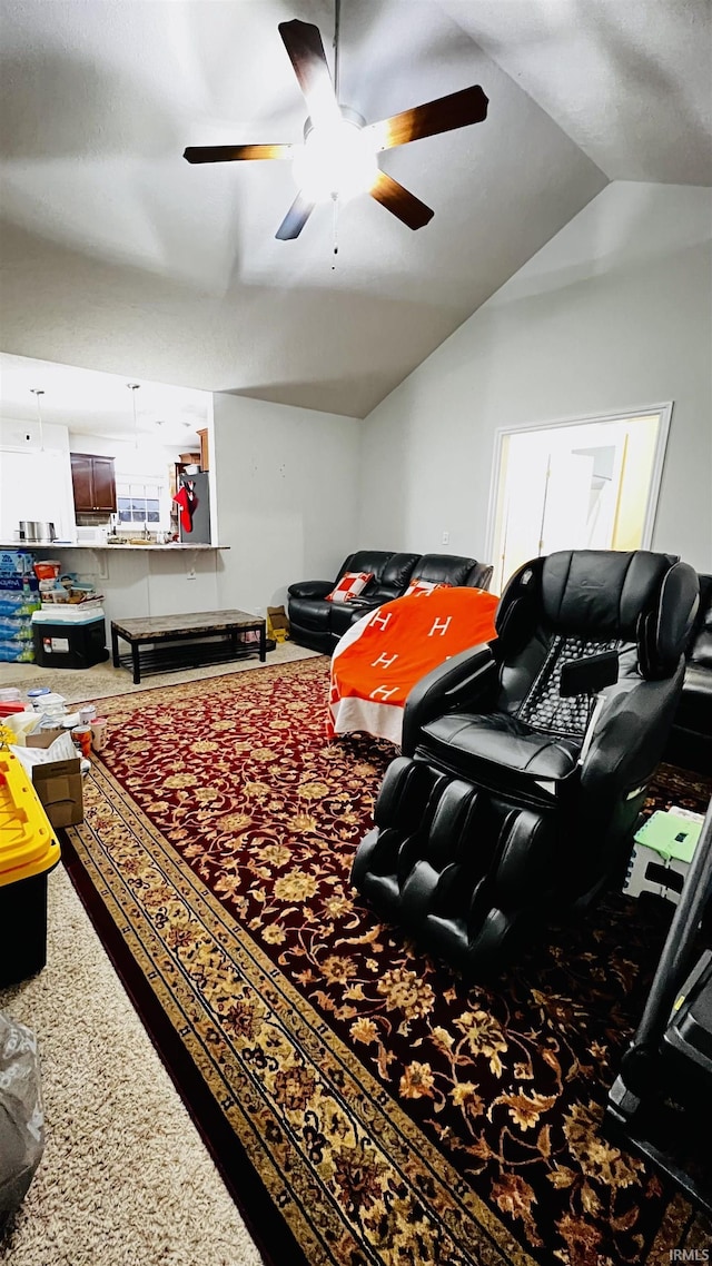 living area with vaulted ceiling and a ceiling fan