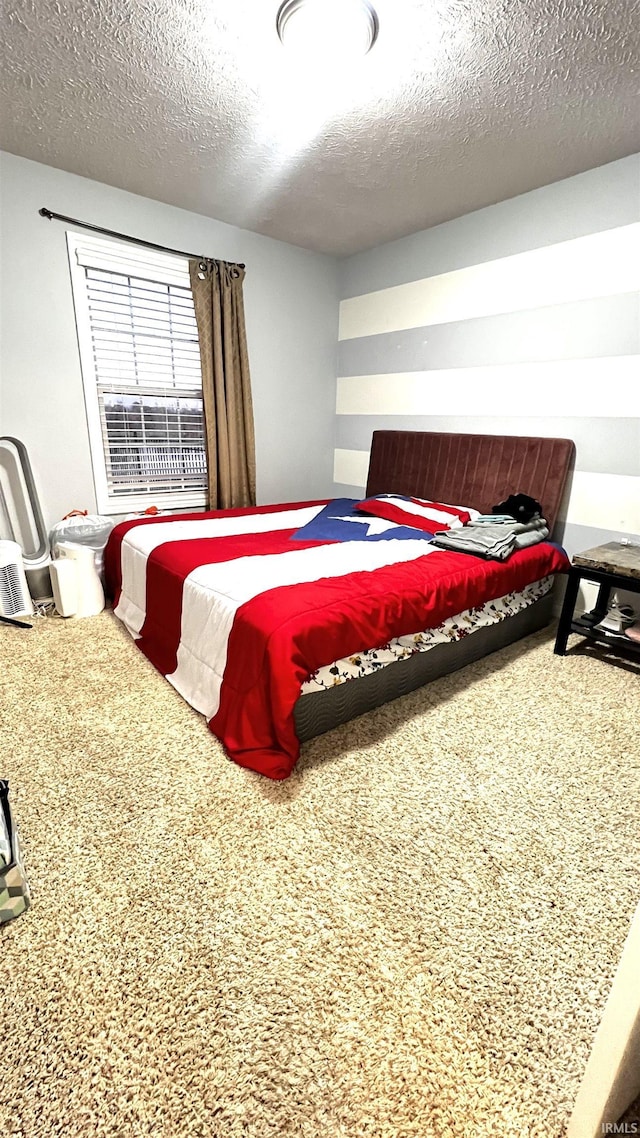 bedroom featuring carpet and a textured ceiling