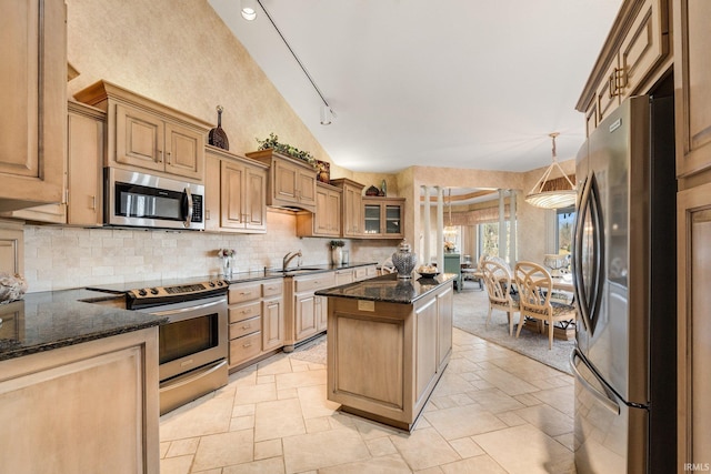 kitchen with stainless steel appliances, dark stone countertops, glass insert cabinets, and stone tile floors