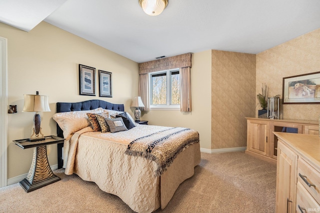 bedroom featuring light colored carpet and baseboards