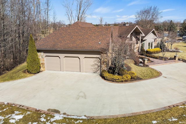 view of front of house featuring an attached garage, stone siding, a shingled roof, and concrete driveway