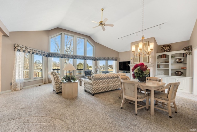 dining room with baseboards, carpet, high vaulted ceiling, track lighting, and ceiling fan with notable chandelier