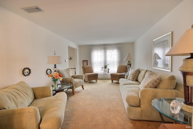 carpeted living room with a baseboard heating unit and visible vents