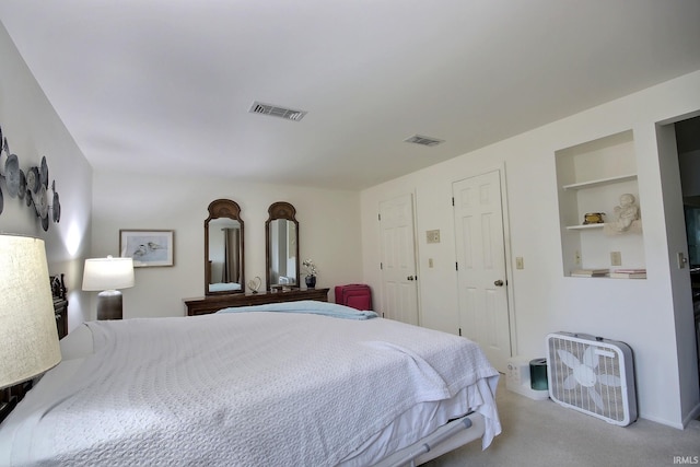 bedroom featuring light carpet and visible vents