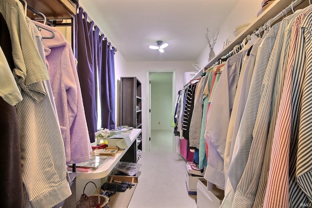 walk in closet featuring light carpet