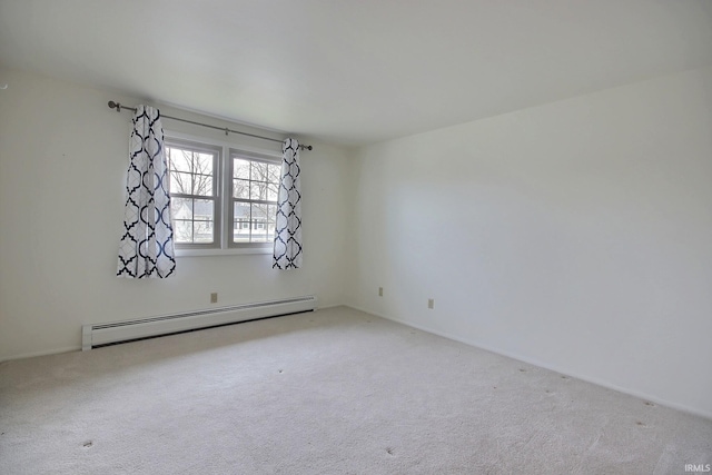 spare room with a baseboard radiator and light colored carpet