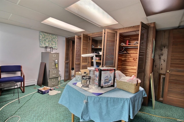 living area with carpet floors and a paneled ceiling