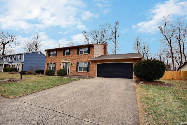 colonial house featuring an attached garage, brick siding, fence, concrete driveway, and a front lawn