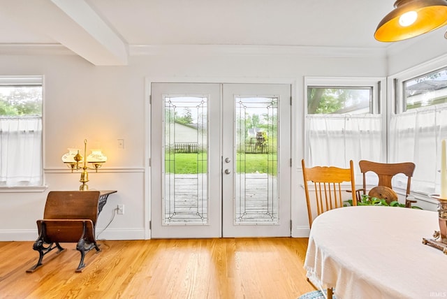 doorway featuring light wood-type flooring, baseboards, ornamental molding, and french doors