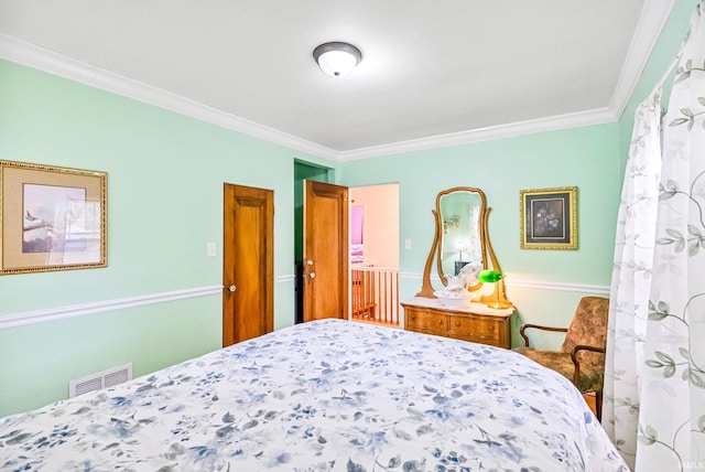 bedroom with visible vents and crown molding