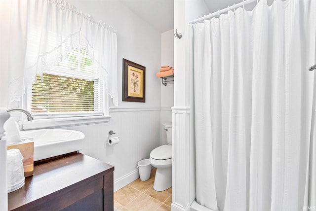 bathroom featuring tile patterned flooring, toilet, a wainscoted wall, vanity, and a shower with curtain