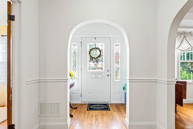 entrance foyer featuring wood finished floors, visible vents, and baseboards