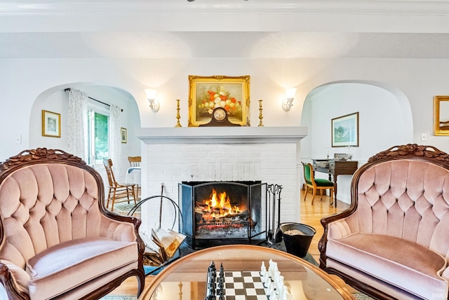 living area with a fireplace and wood finished floors