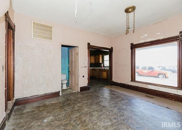 spare room with stone finish flooring and visible vents