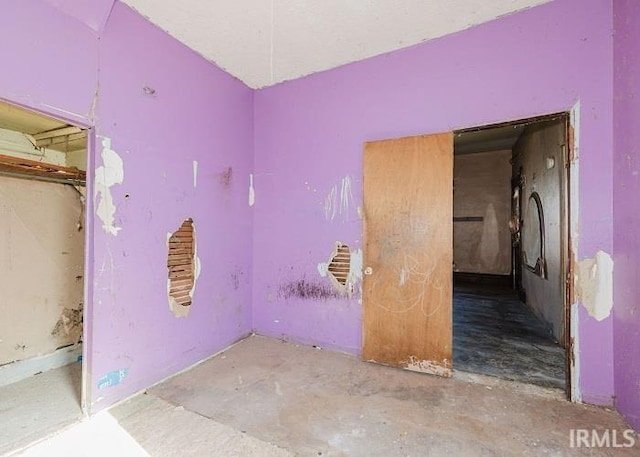 spare room featuring unfinished concrete floors