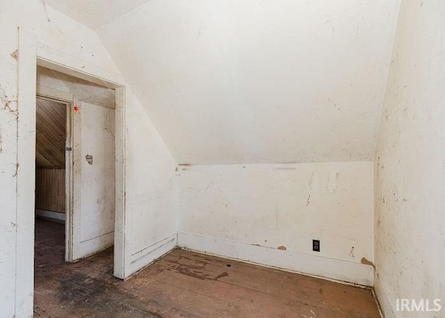 bonus room with lofted ceiling and dark wood finished floors