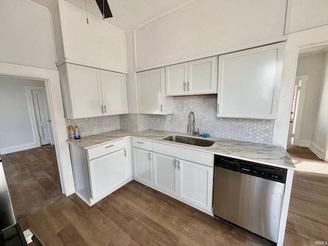 kitchen with dark wood-style flooring, white cabinets, dishwasher, and a sink