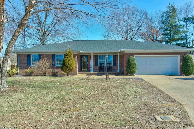 ranch-style home with an attached garage, driveway, a front yard, and brick siding