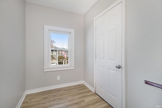 empty room featuring light wood-style flooring and baseboards