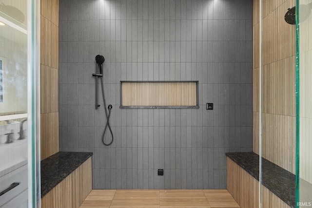 bathroom with a walk in shower and tile walls