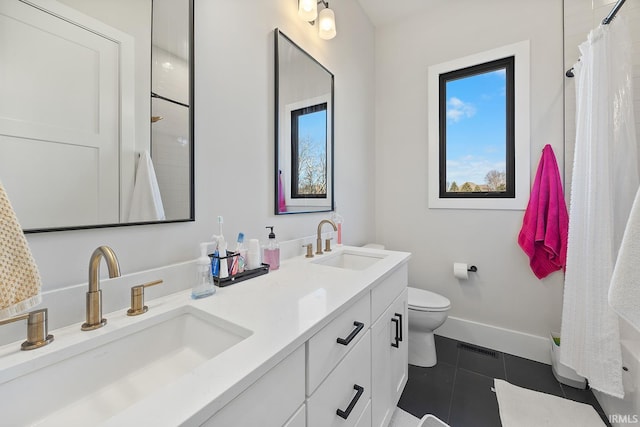 full bathroom with baseboards, double vanity, a sink, and tile patterned floors