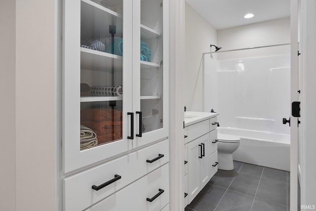 full bath with toilet, recessed lighting, vanity, tile patterned floors, and washtub / shower combination