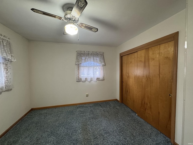 unfurnished bedroom featuring a ceiling fan, carpet, a closet, and baseboards