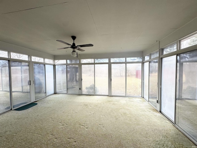 unfurnished sunroom featuring ceiling fan