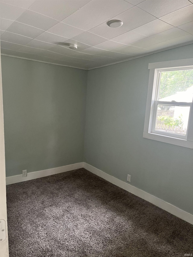 spare room with carpet and baseboards