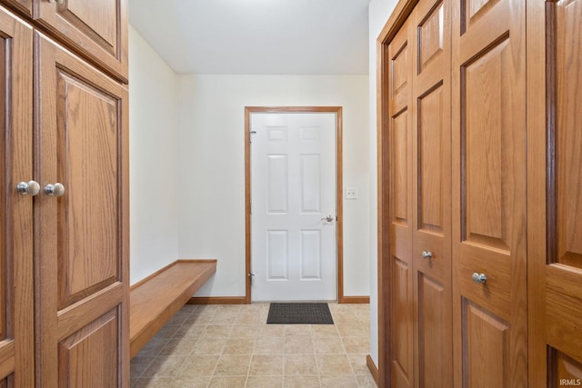 mudroom featuring light tile patterned floors and baseboards