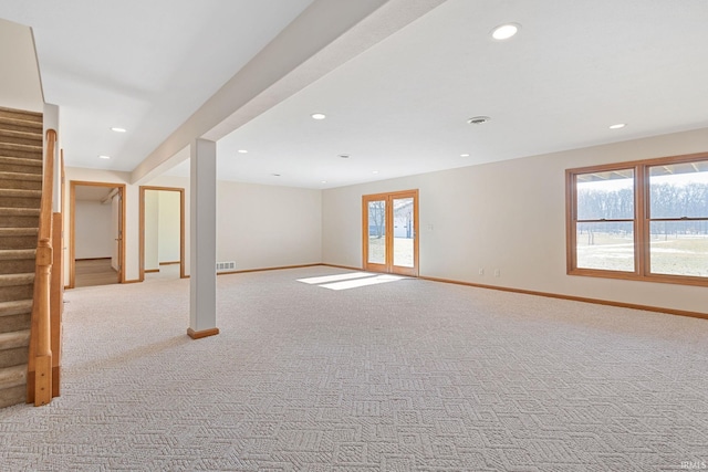 basement featuring stairway, recessed lighting, light colored carpet, and baseboards