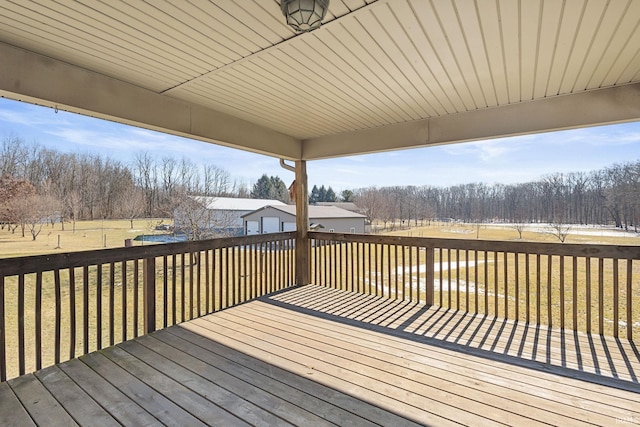 wooden deck featuring a lawn