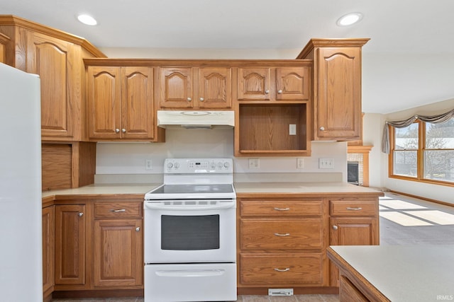 kitchen featuring recessed lighting, white appliances, light countertops, and under cabinet range hood