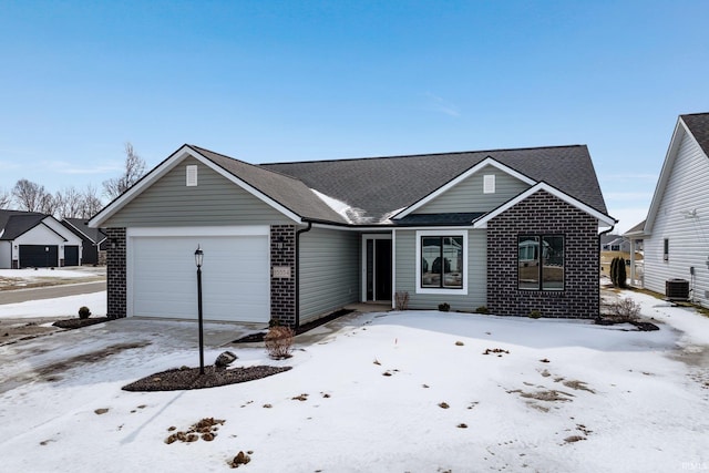 ranch-style house with a garage, brick siding, roof with shingles, and central AC unit