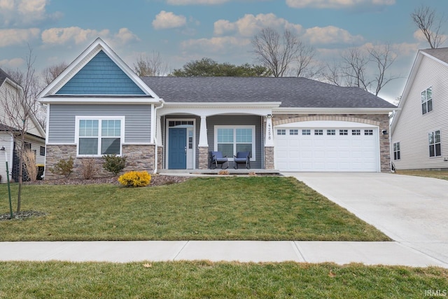 view of front of house featuring a garage, concrete driveway, stone siding, roof with shingles, and a front yard