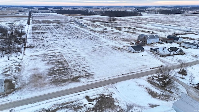 snowy aerial view featuring a rural view