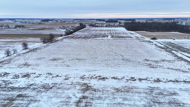 snowy aerial view featuring a rural view