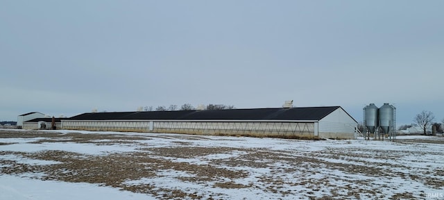 yard covered in snow featuring an outbuilding and an outdoor structure