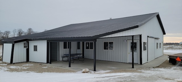 snow covered house with metal roof