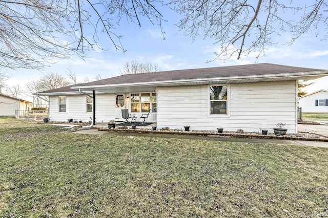 rear view of property with a lawn